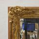 Antique gilded mirror, 19th century Empire style.