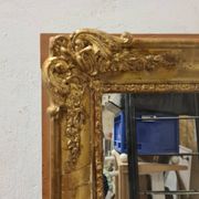Antique gilded mirror, 19th century Empire style.