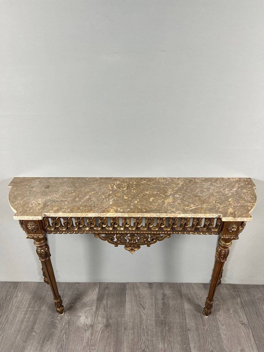 Louis XVI style console in carved wood with a gilded patina, 19th century.