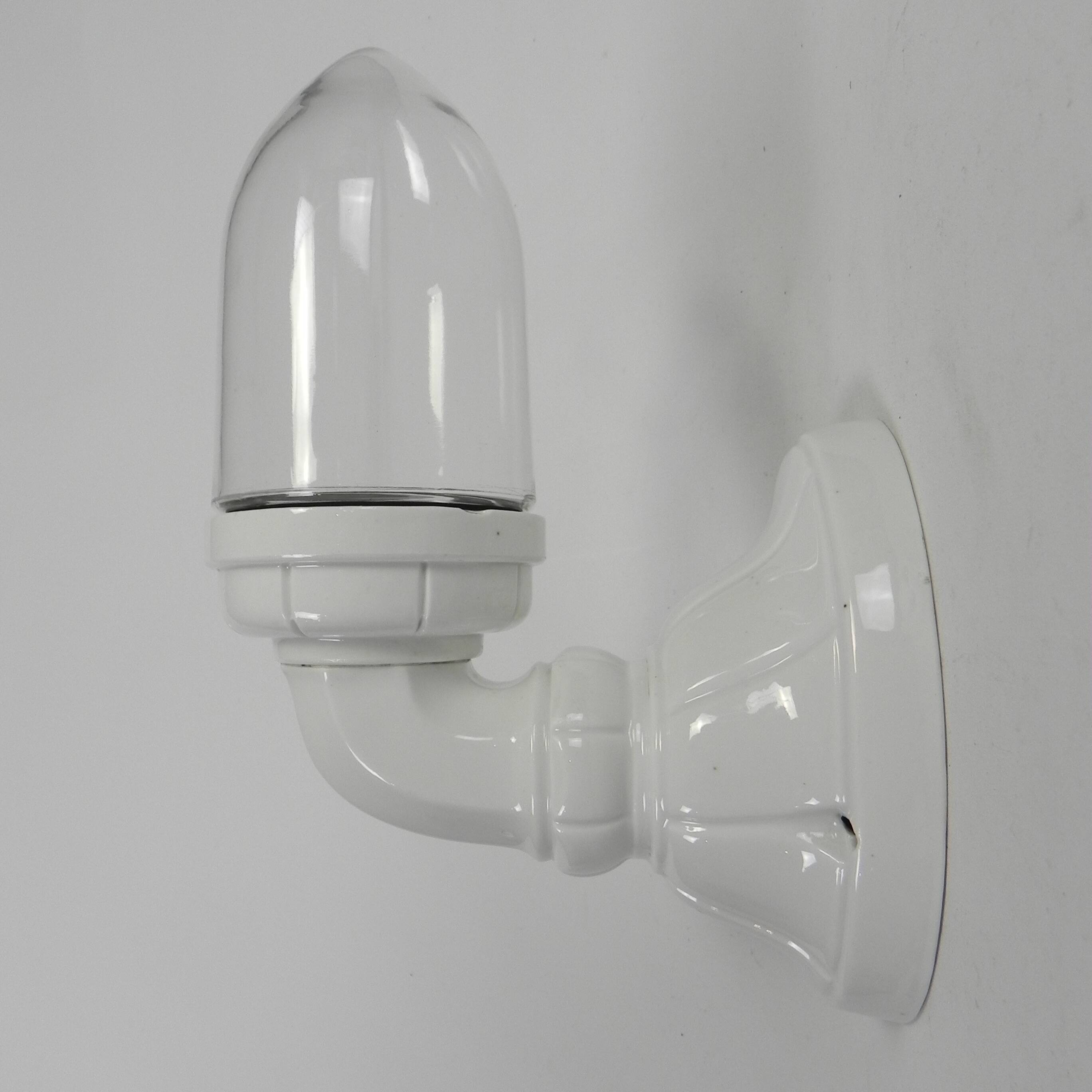 Wall lamp in porcelain with a transparent glass shade, 1930s.