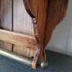 Small antique wall shelf with a drawer in light solid wood.