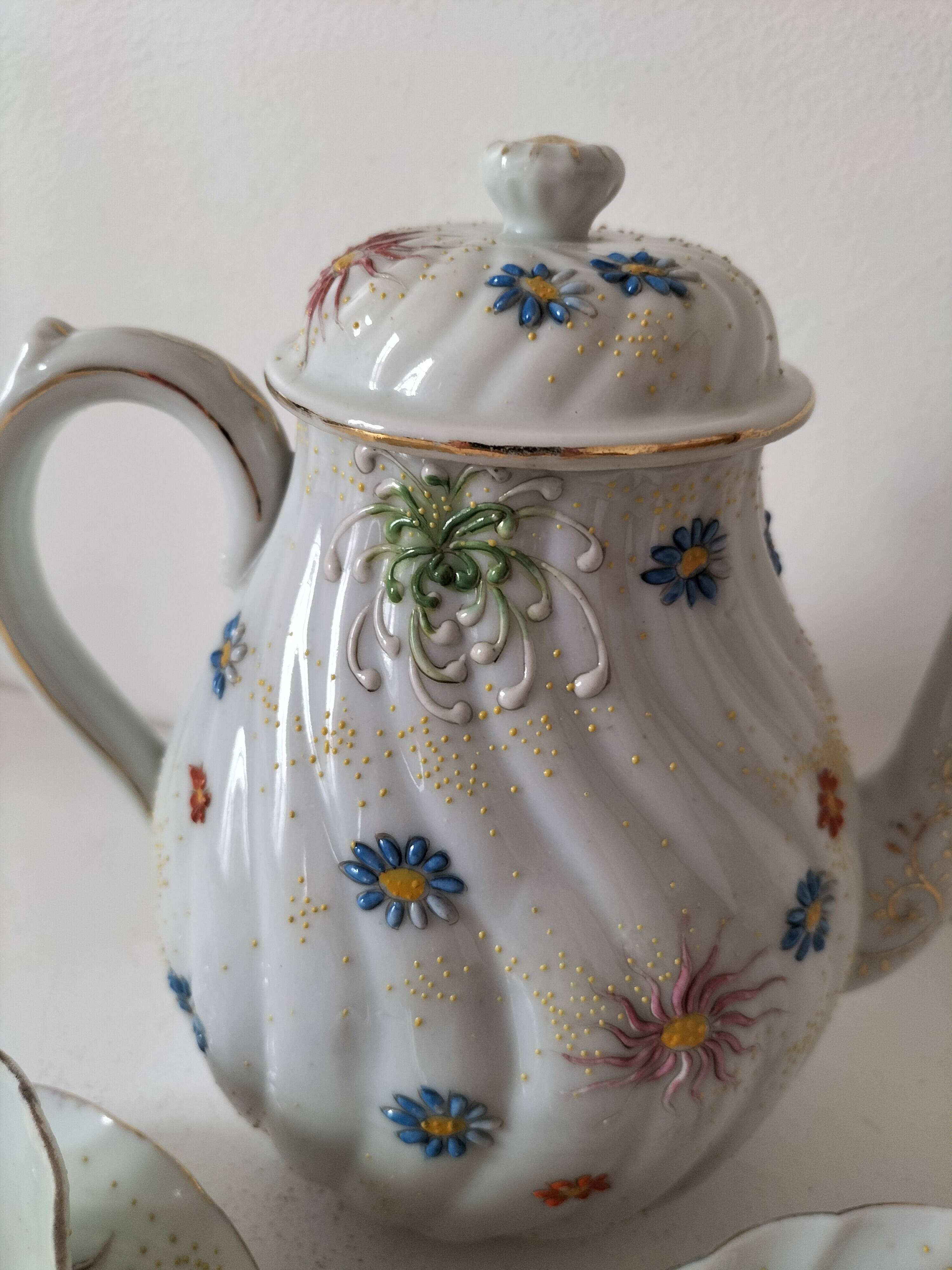 coffee pot, cup and saucers