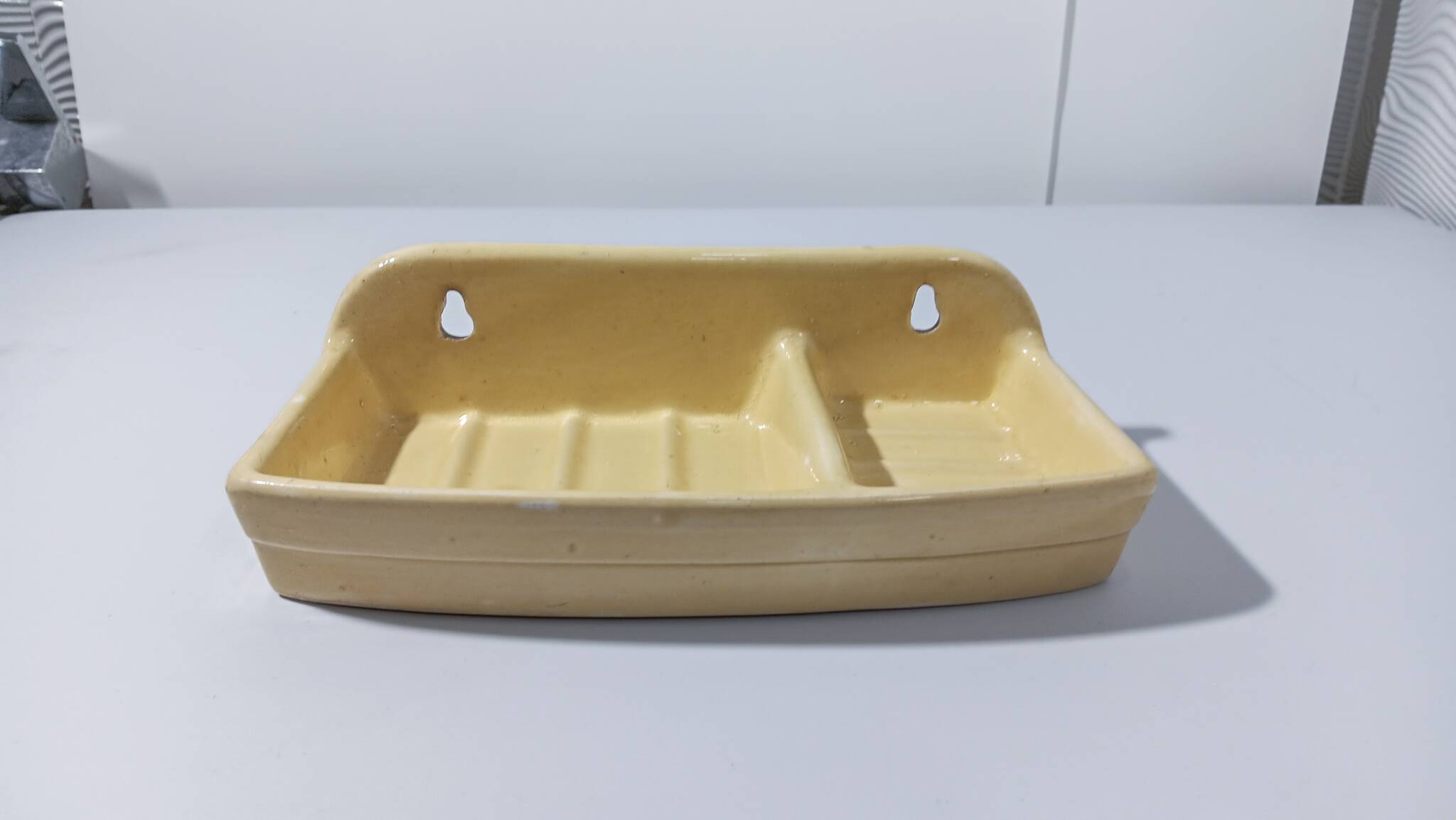 Pale yellow ceramic soap dish