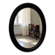 Antique oval mirror in patinated black wood