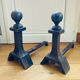 Pair of massive antique-style fire dogs in solid iron from the 20th century.