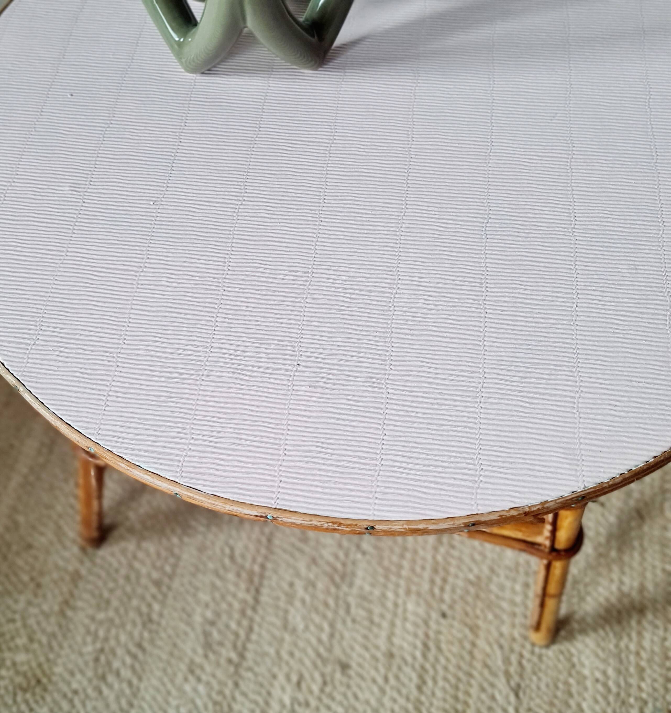 Round soft pink rattan table
