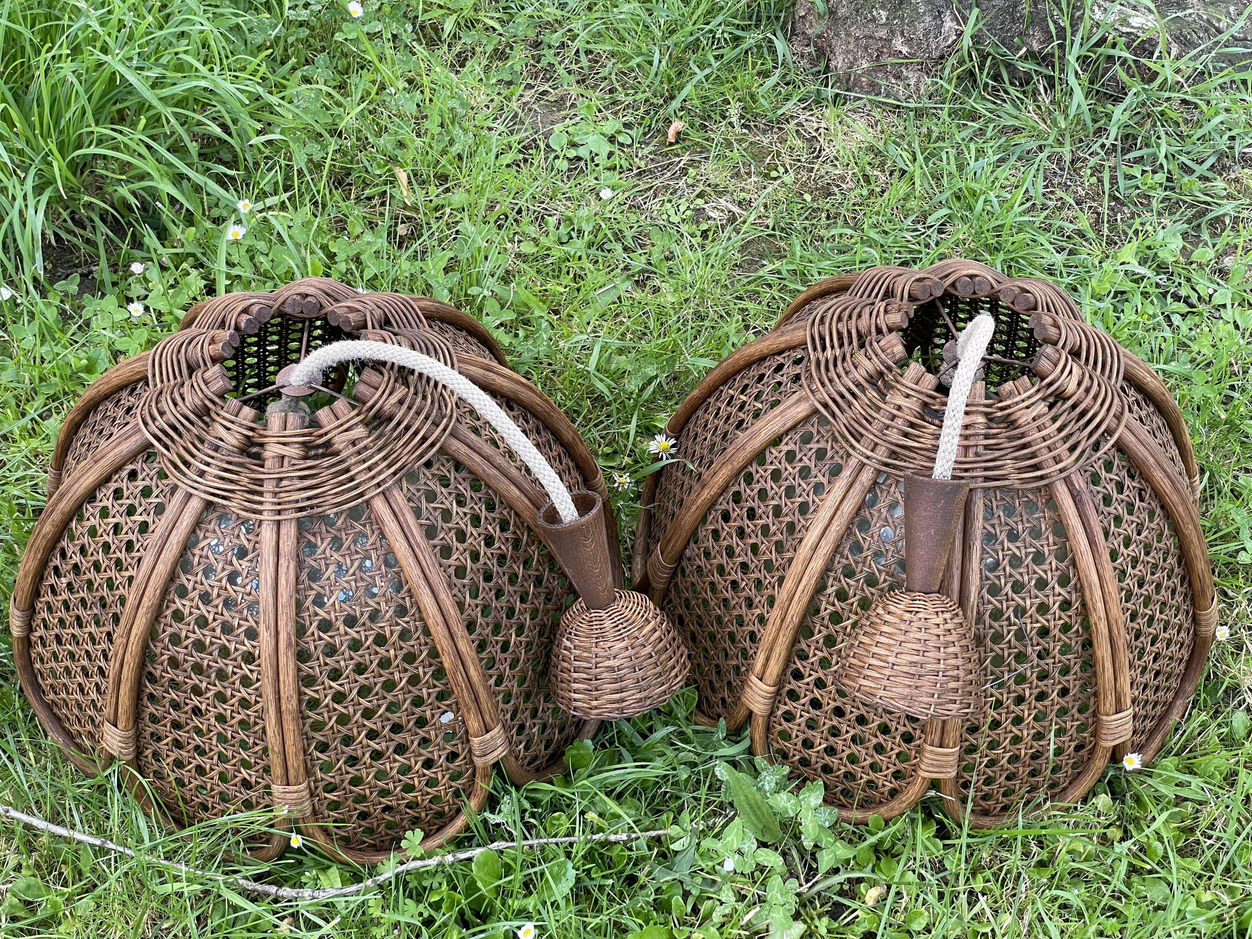 Duo of rattan and glass chandeliers