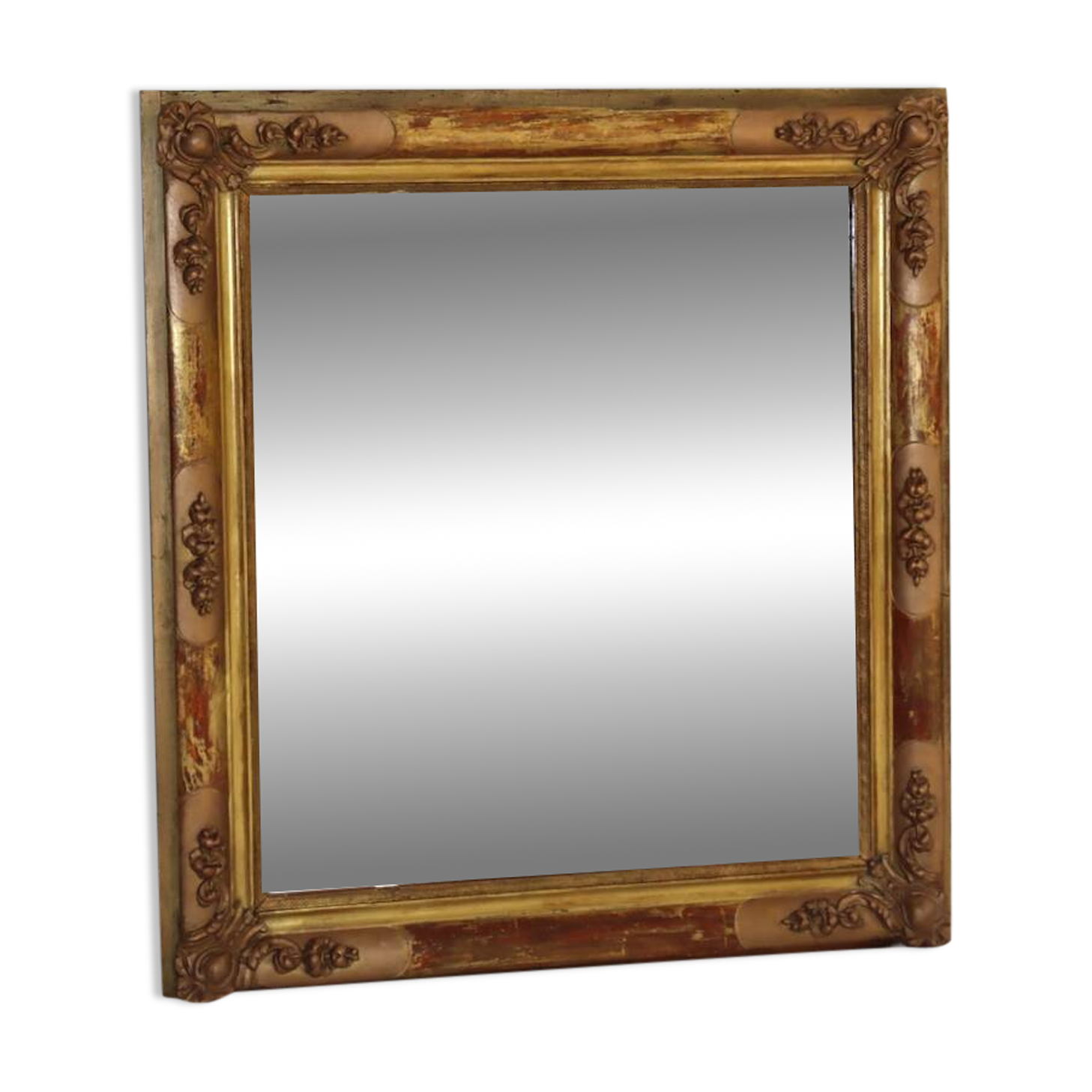 Rectangular mirror in gilded wood with relief decoration of flowers.