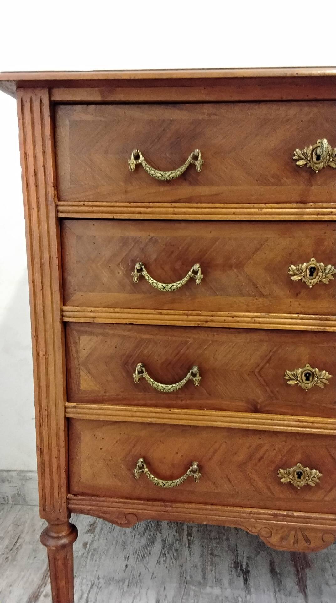 Antique marquetry commode in the Louis XVI style.