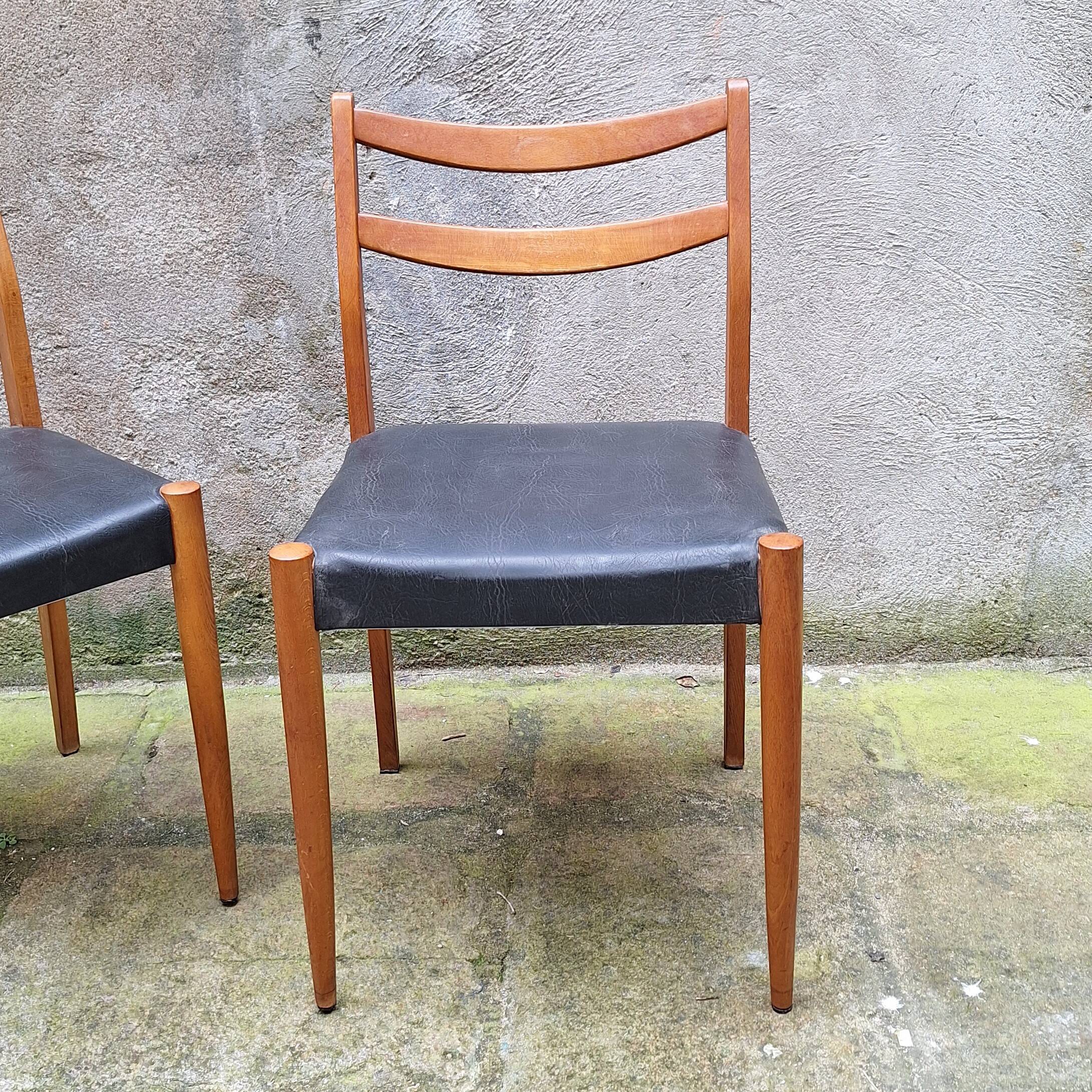 Pair of Scandinavian style chairs in wood and faux leather.