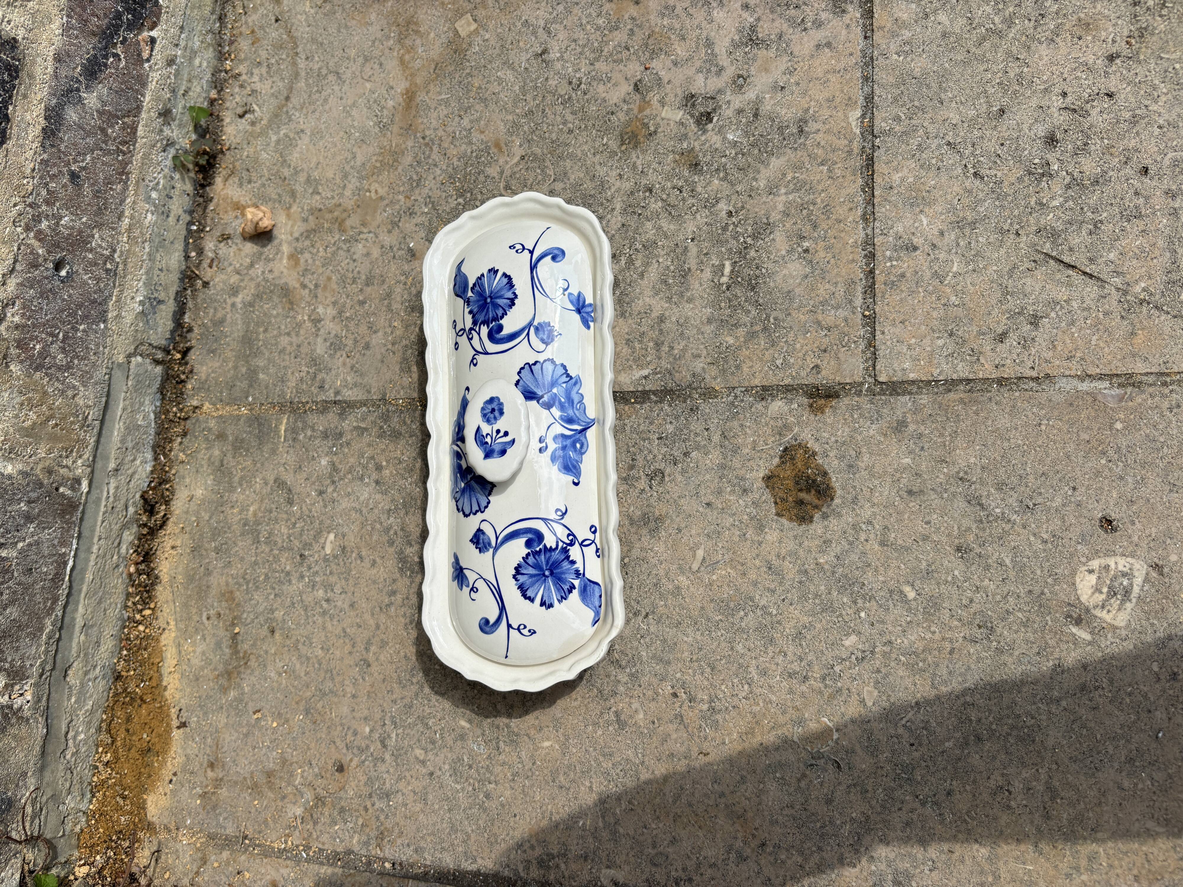 Antique butter dish in earthenware, blue and white floral decoration.