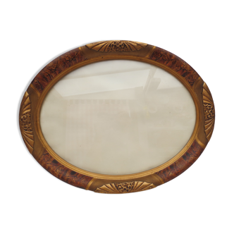 Old oval wooden frame in art nouveau style glazed flamed and gilded color