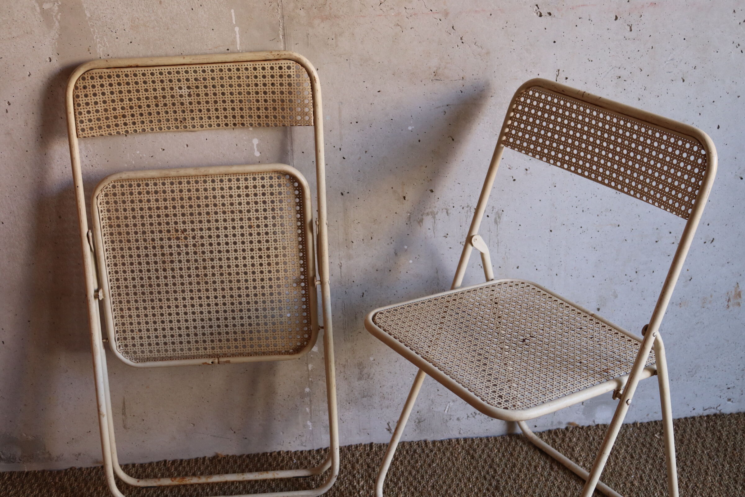 Two metal tanned folding chairs