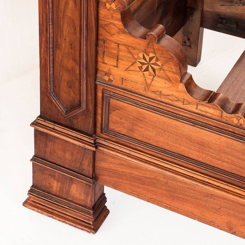 Bed made of solid walnut with marquetry details. France, 1930s.