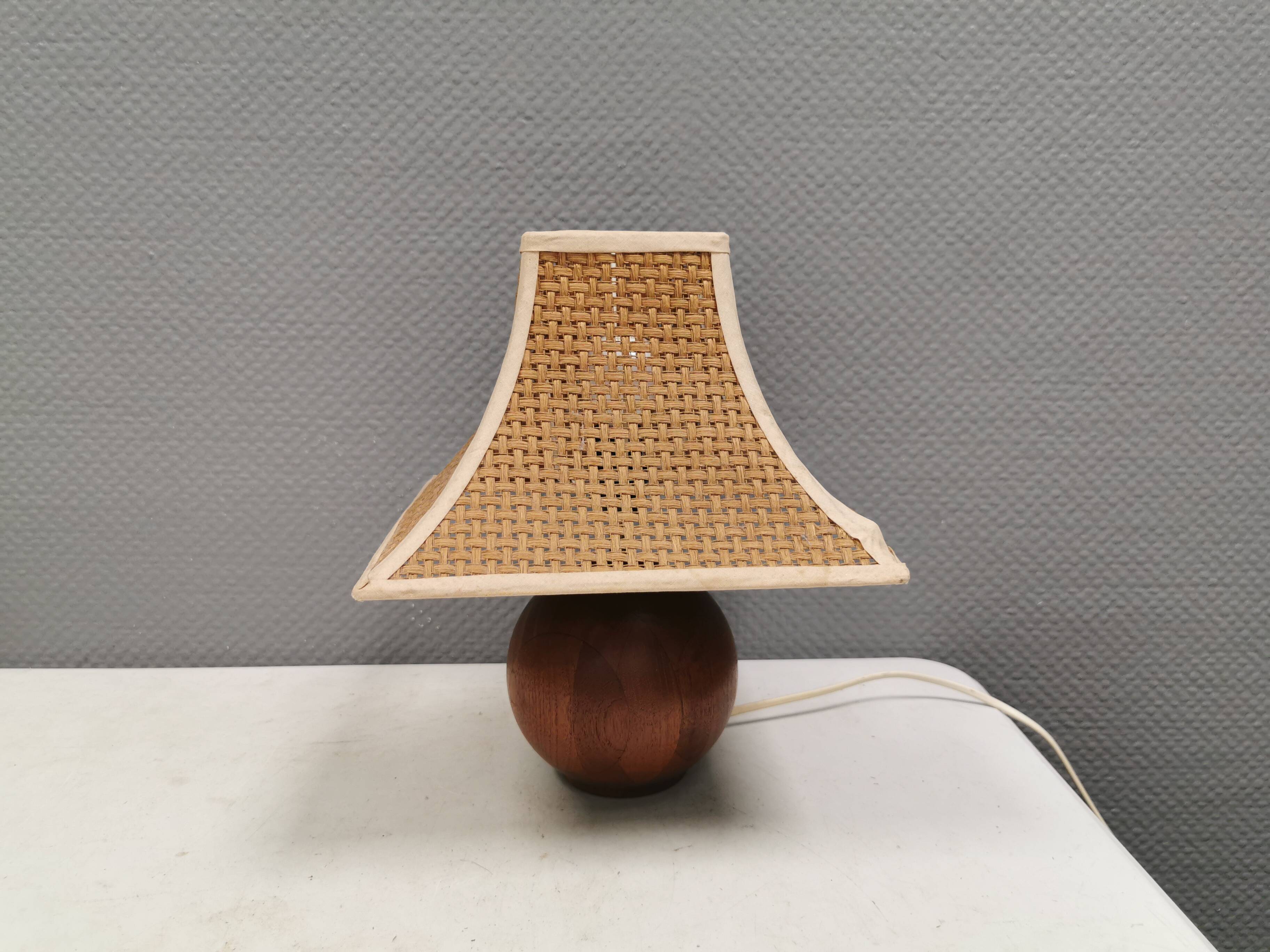 Very rare table lamp in turned teak wood with original braided shade. 1970s