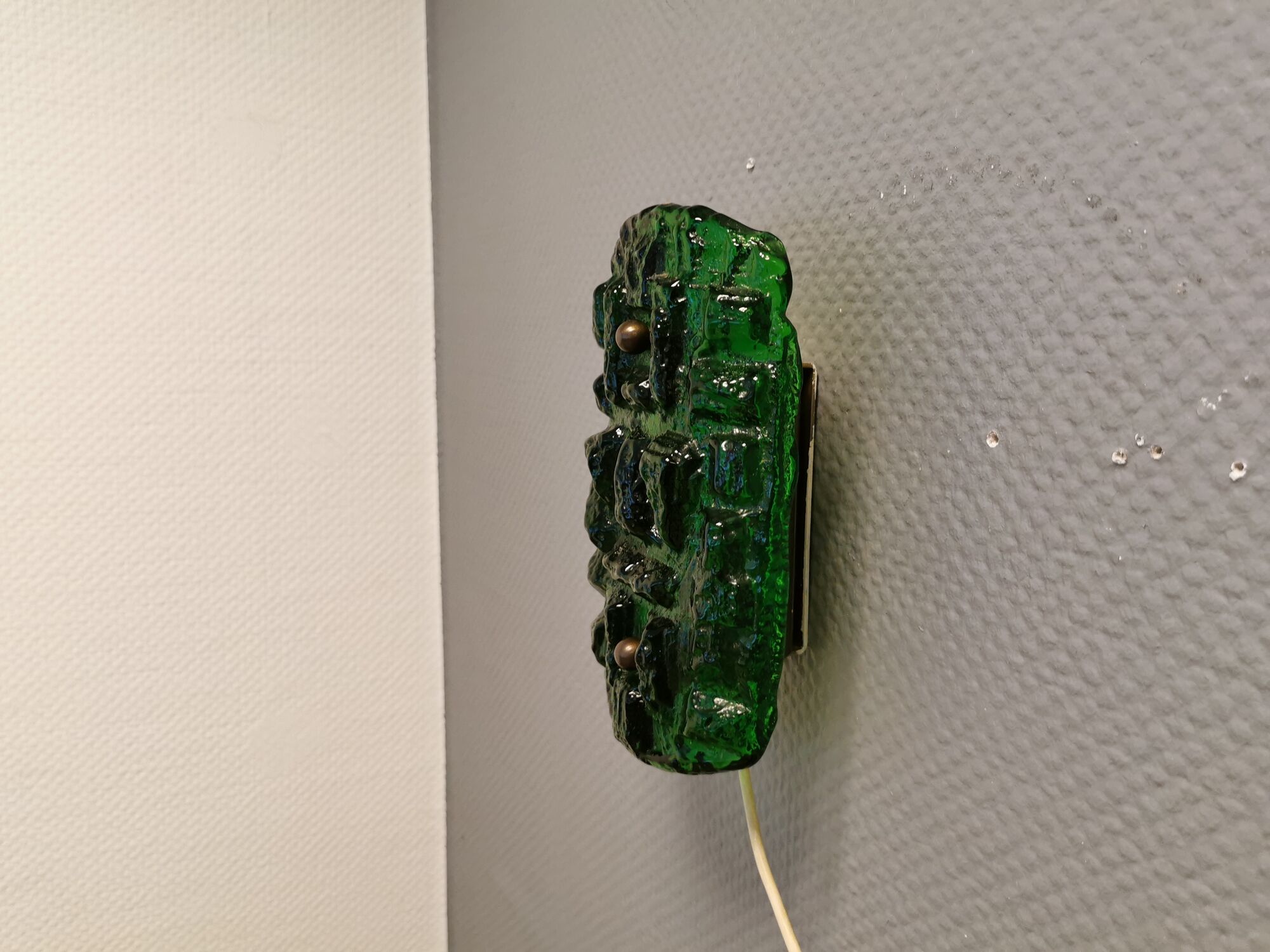 Old wall lamp made of hard pressed green glass.