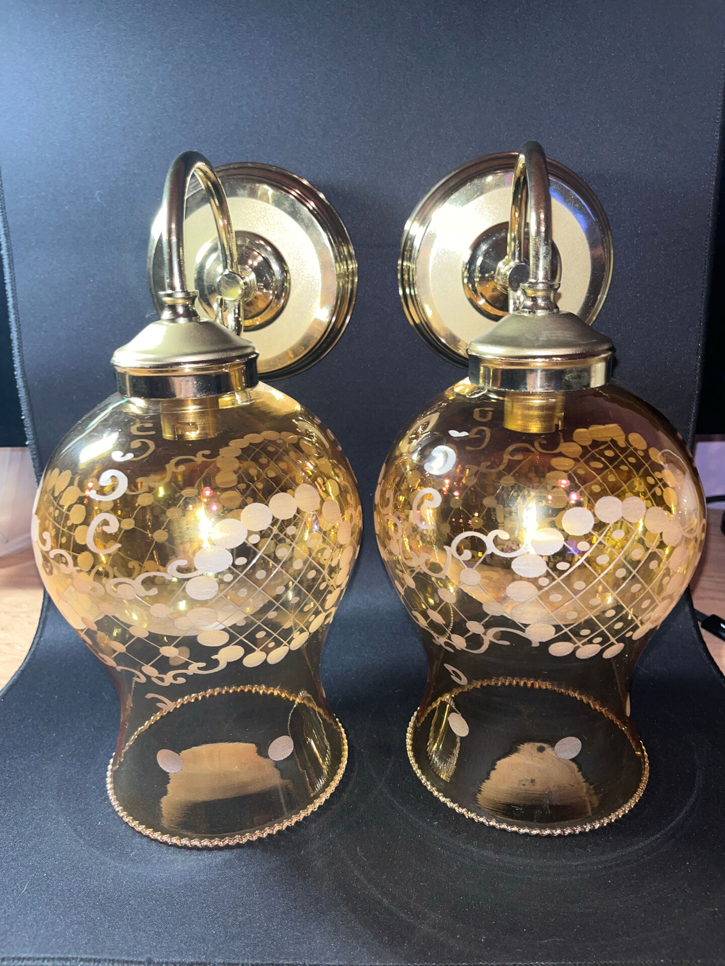 Pair of vintage wall sconces in brass with amber glass globes.