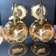 Pair of vintage wall sconces in brass with amber glass globes.