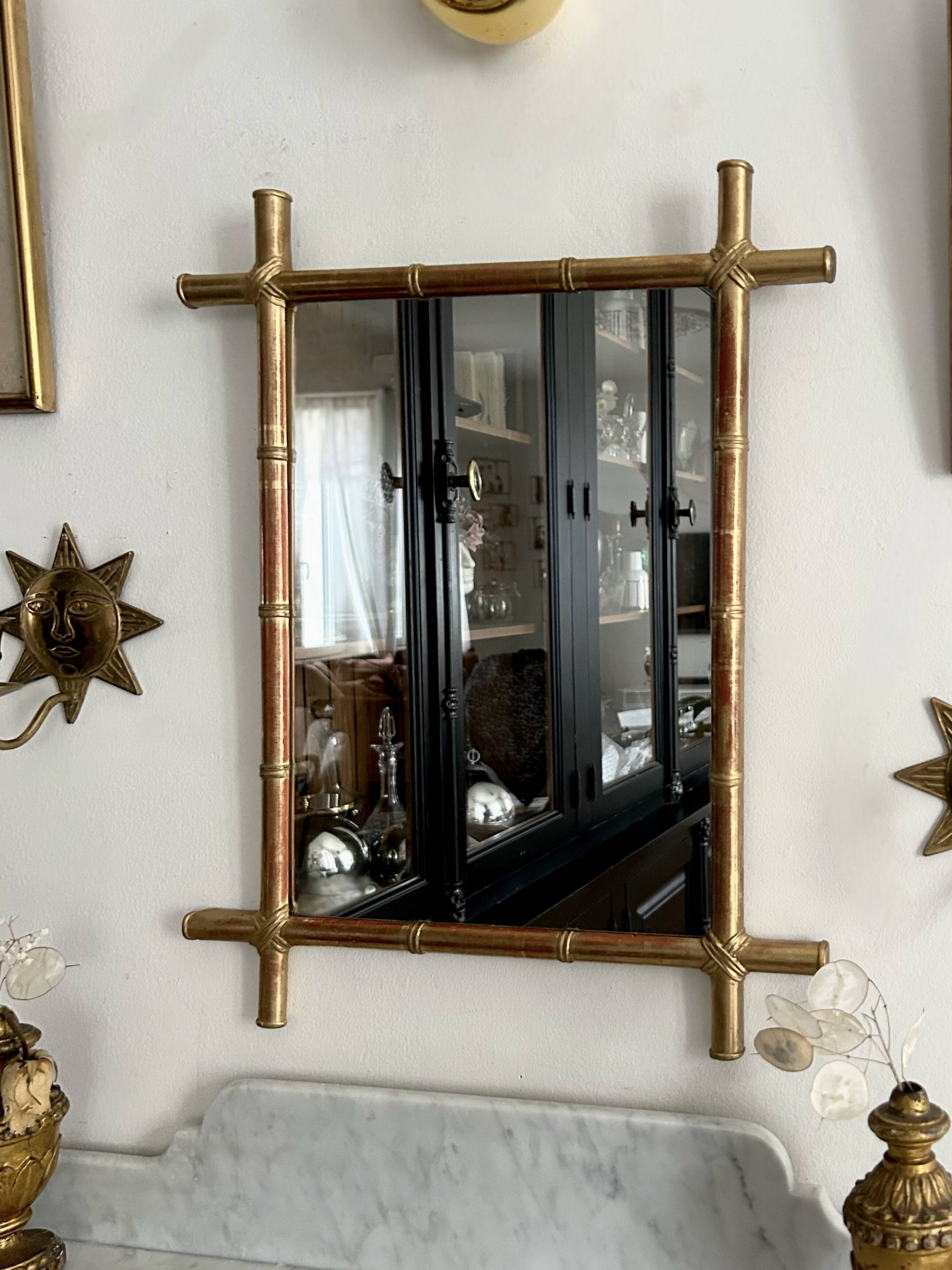 Mirror in gilded stucco, bamboo patina and gold leaf.