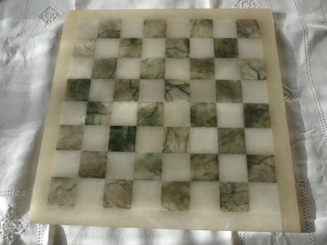 Onyx chessboard and complete wooden chess set.