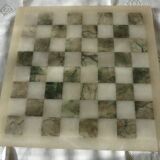 Onyx chessboard and complete wooden chess set.