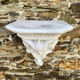 Antique wall console in patinated white plaster.