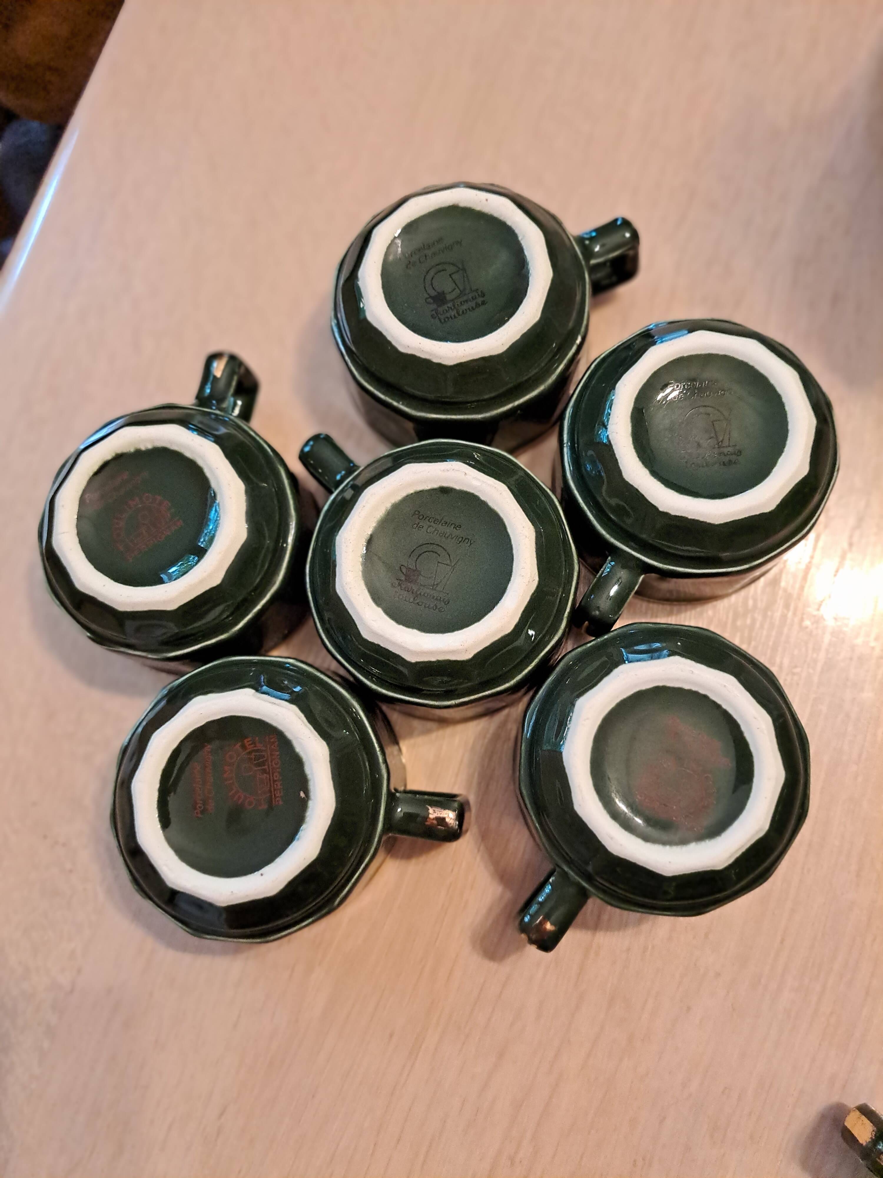 Green and gold coffee cups and sub-cups