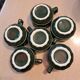 Green and gold coffee cups and sub-cups