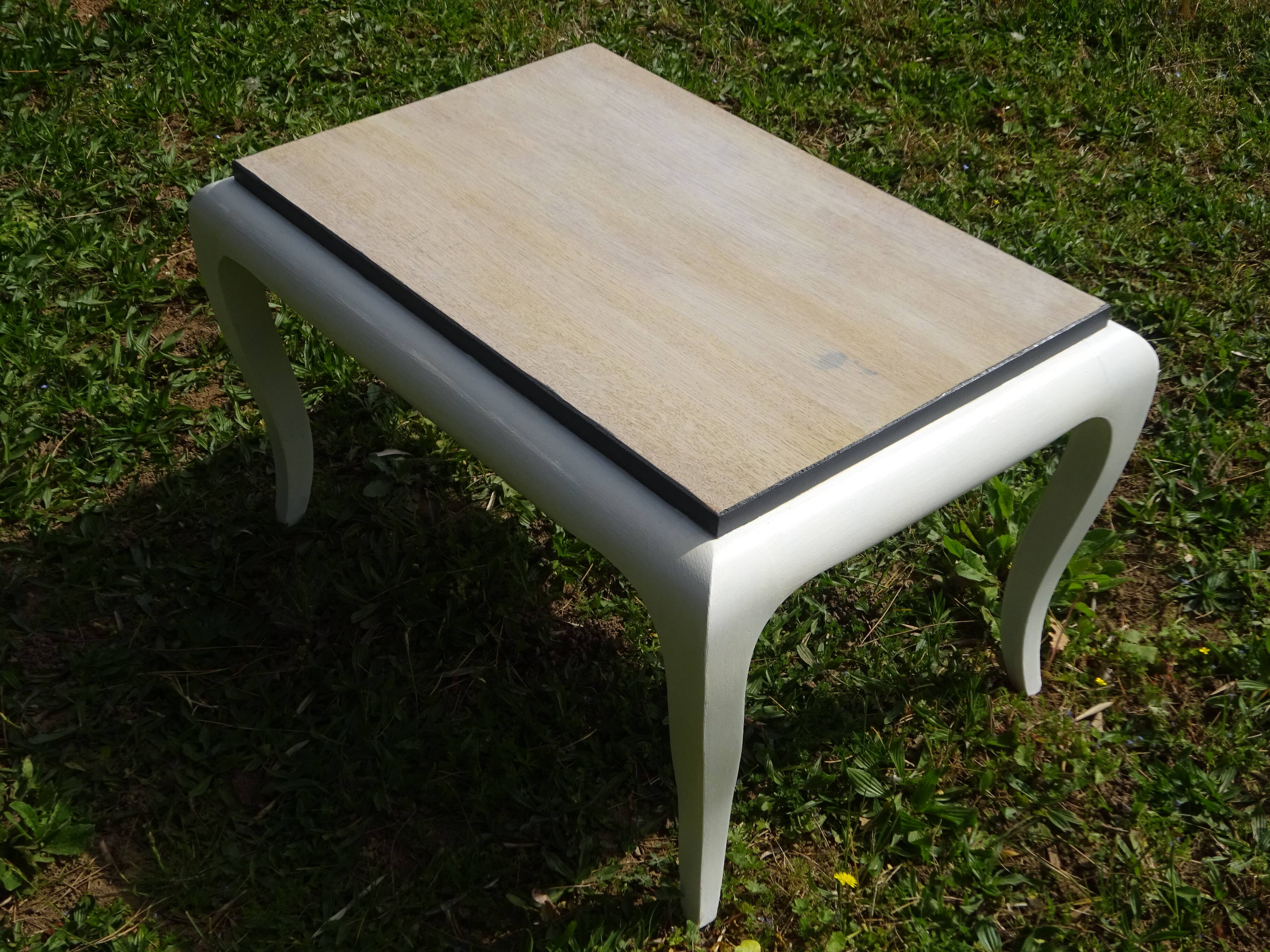 Oak coffee table with curved legs.