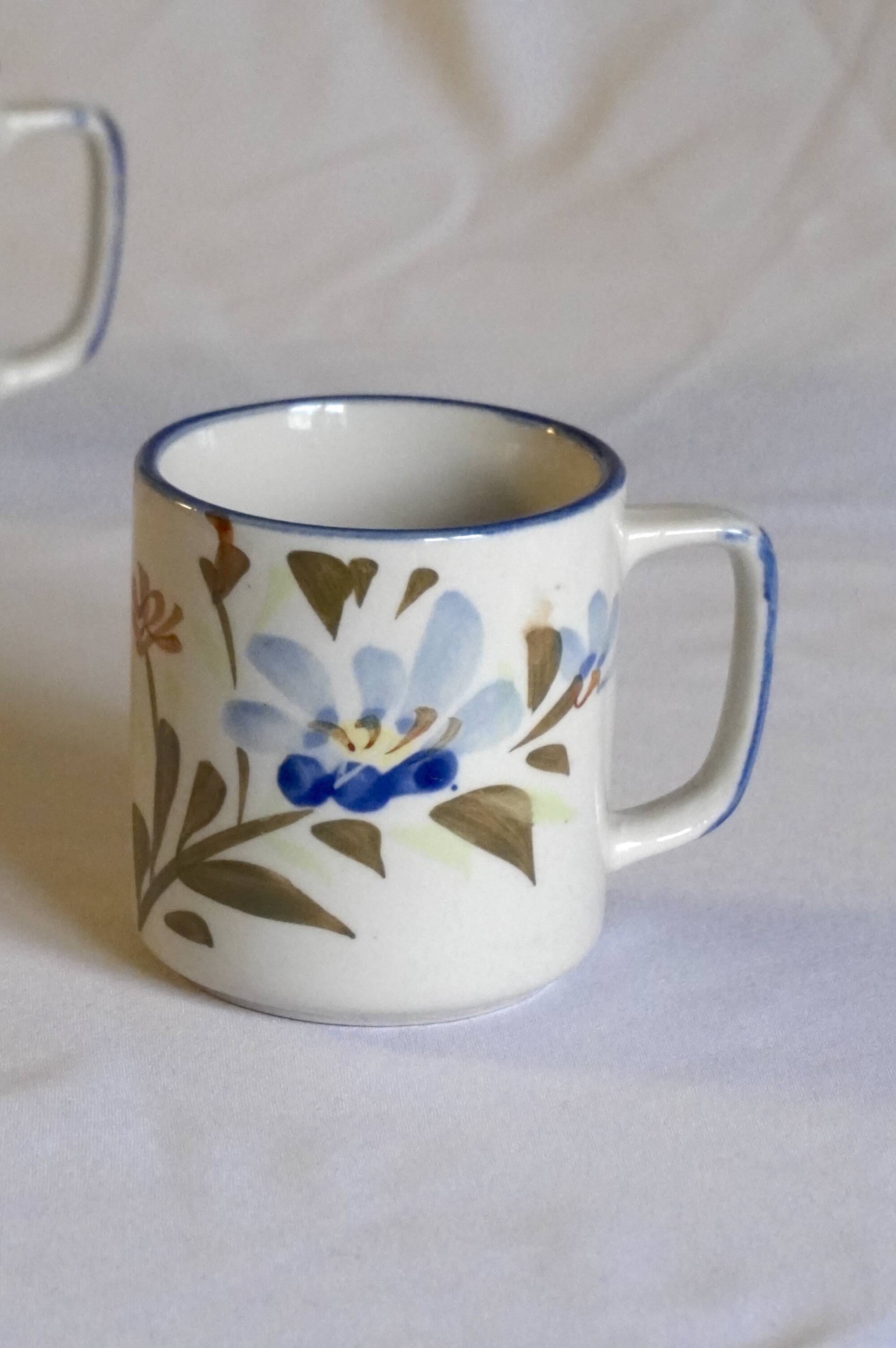 Set of 4 stoneware cups/mugs with blue floral designs, made in China.