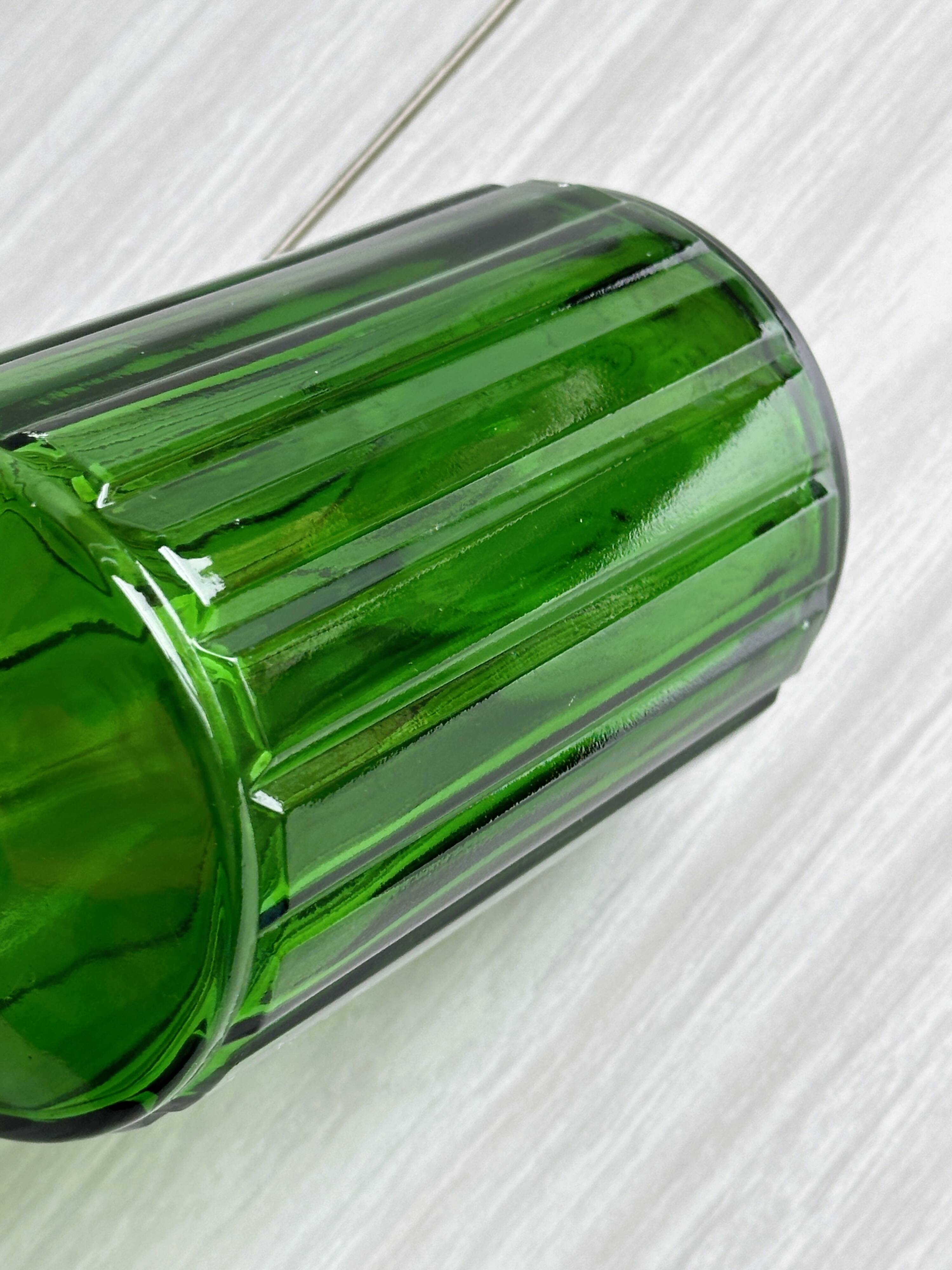 Green glass bottle, ribbed design.