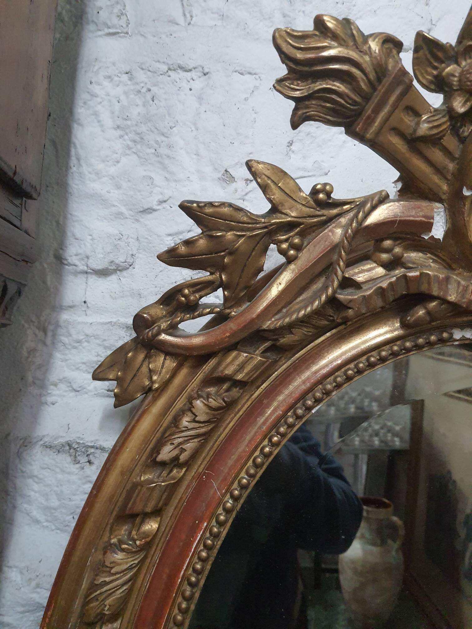 Golden oval mirror