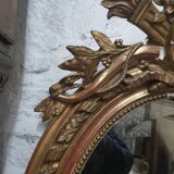 Golden oval mirror