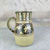 Glazed earthenware pitcher signed Riou.