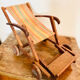 Vintage wooden folding doll's deckchair on wheels
