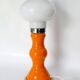 Table lamp or bedside lamp from the 1960s-70s in orange and chrome.