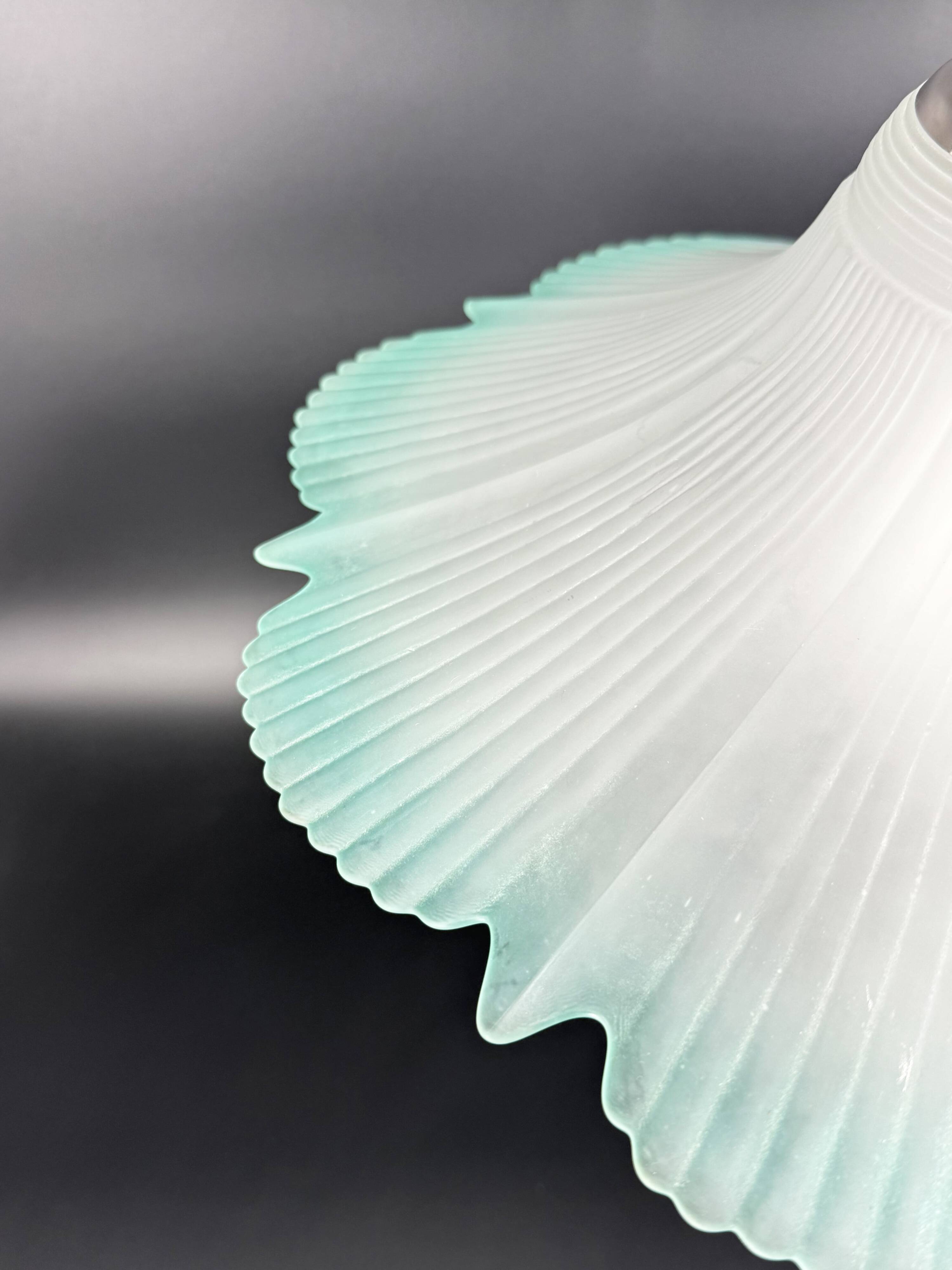 Frosted glass flower pendant with a water green edge.