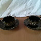 Black cups and saucers with relief decoration