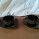 Black cups and saucers with relief decoration