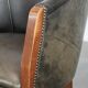 Set of two cowhide and wooden tub chairs with a sturdy colour scheme