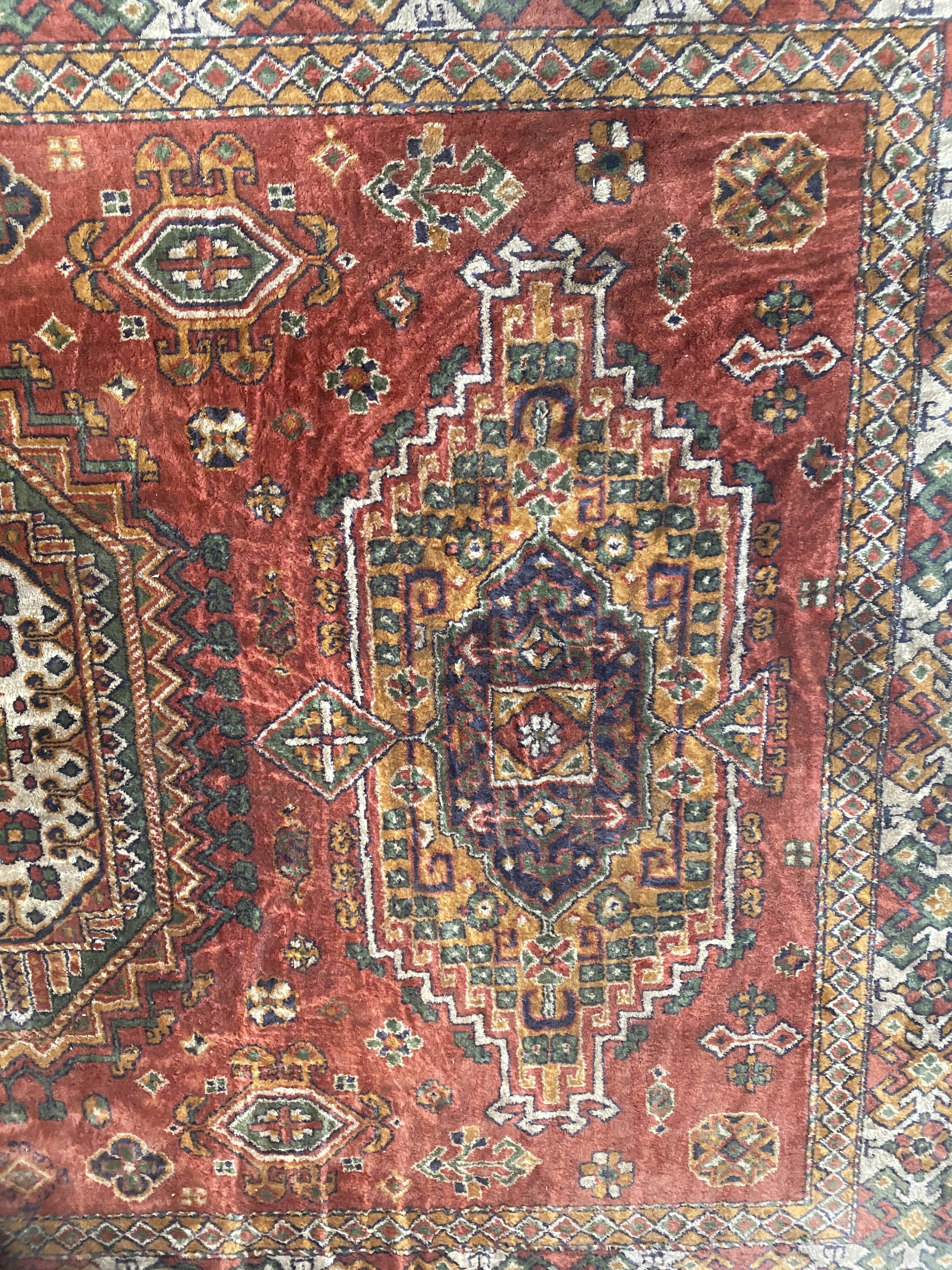 Antique wool rugs with designs on a red background, 20th century.
