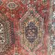 Antique wool rugs with designs on a red background, 20th century.