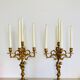 Solid bronze candlesticks decorated with putti, acanthus leaves and lion heads