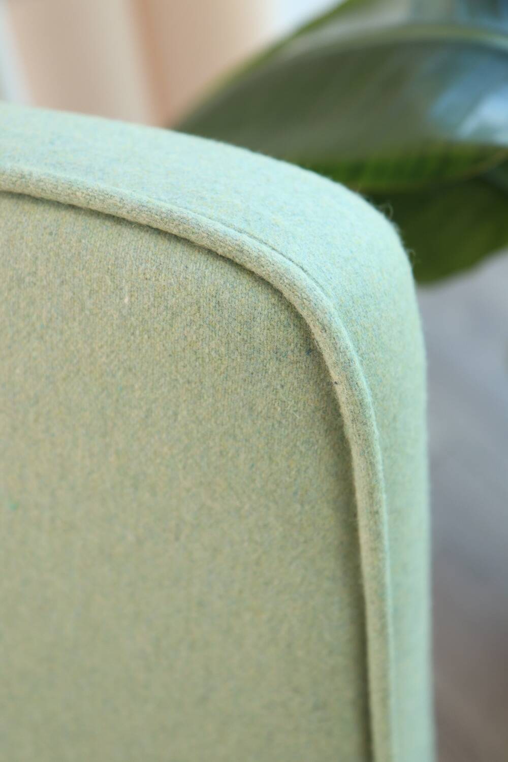 Vintage armchair in mint green wool, mid-century modern design.