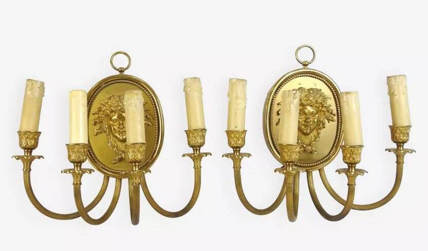 Pair of wall sconces with a relief decoration of a Bacchus mask.