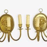 Pair of wall sconces with a relief decoration of a Bacchus mask.