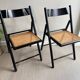 Vintage folding chairs in black wood and cane.