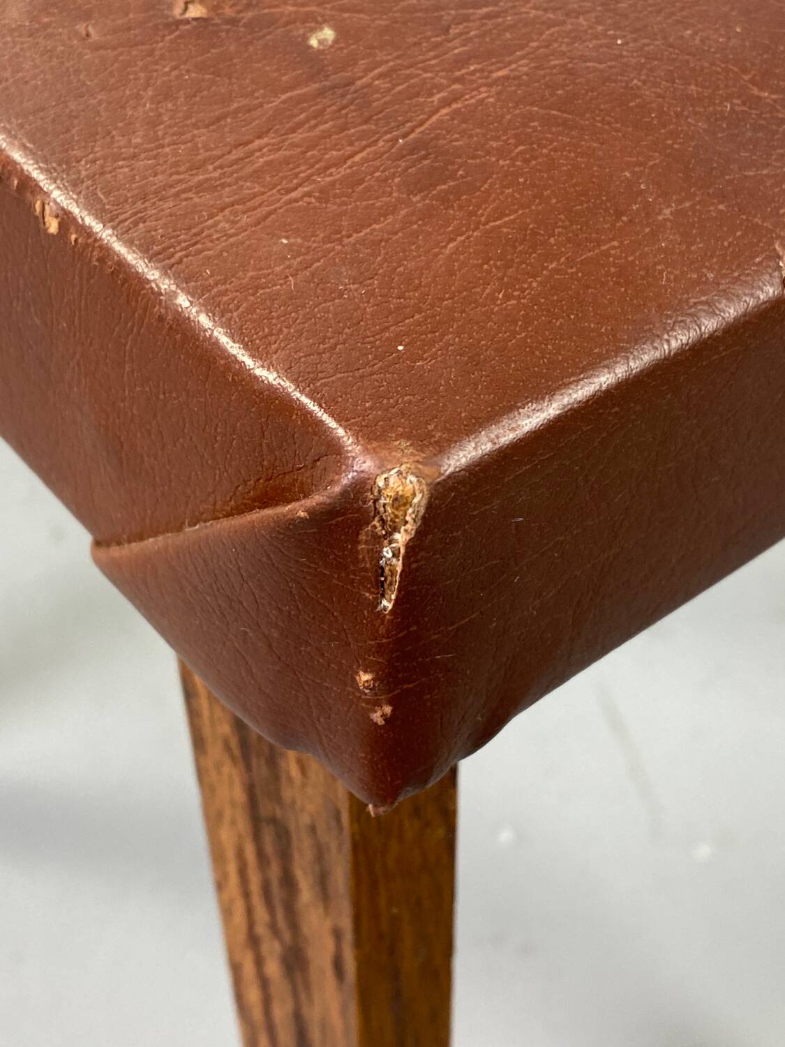 Small stool or footrest in wood and leather