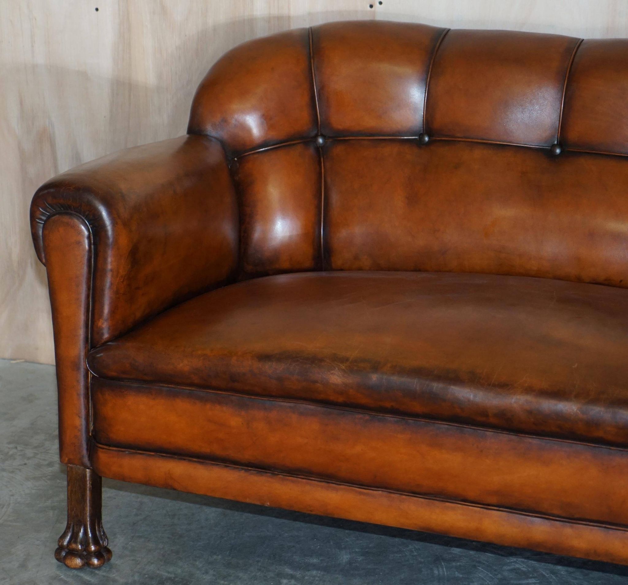Victorian Chesterfield leather canapé with oak lion claw feet.