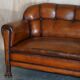 Victorian Chesterfield leather canapé with oak lion claw feet.